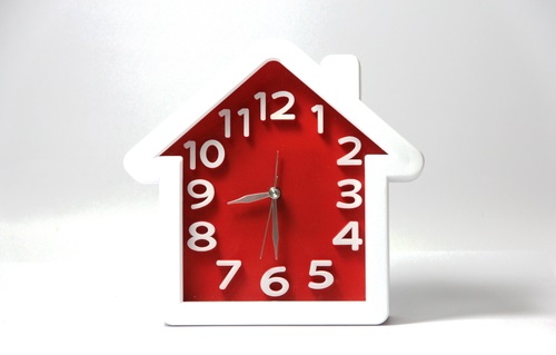 house shaped alarm clock - an article on how long it takes to sell a house.