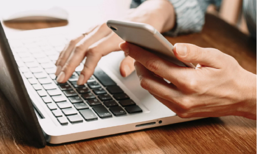 Person on laptop and mobile
